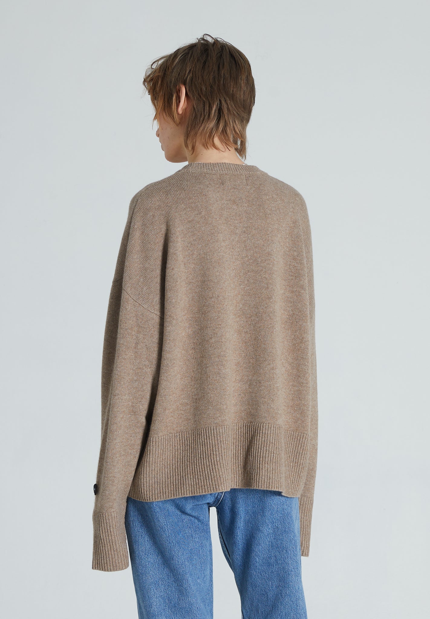 back of woman wearing a rown cashmere crewneck