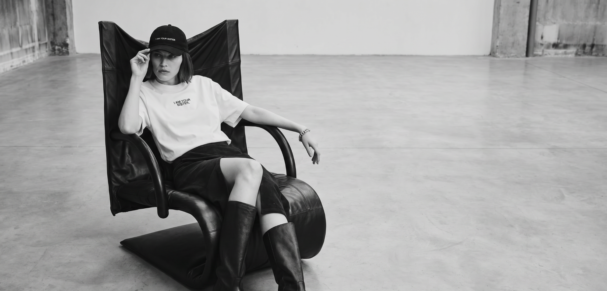 Woman sitting in a modern chair in a minimalistic room